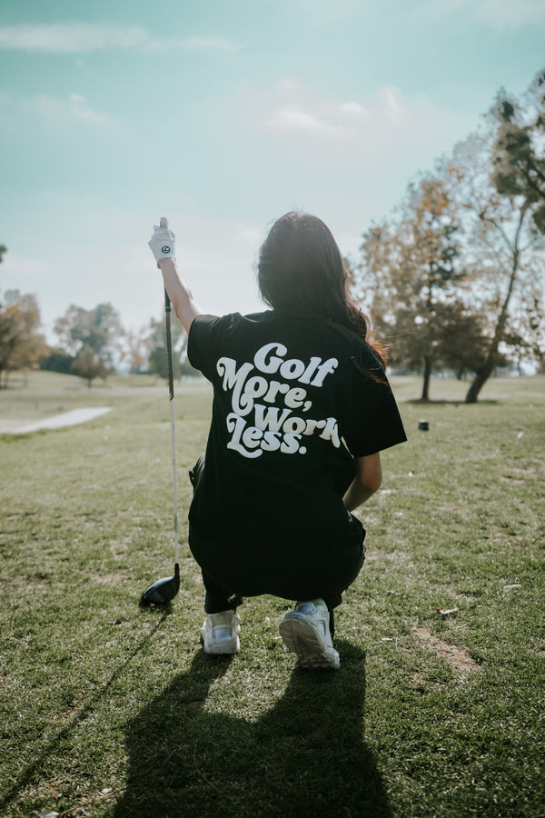 Golf After 5 "Golf More, Work Less" women's black t-shirt, back view, female model